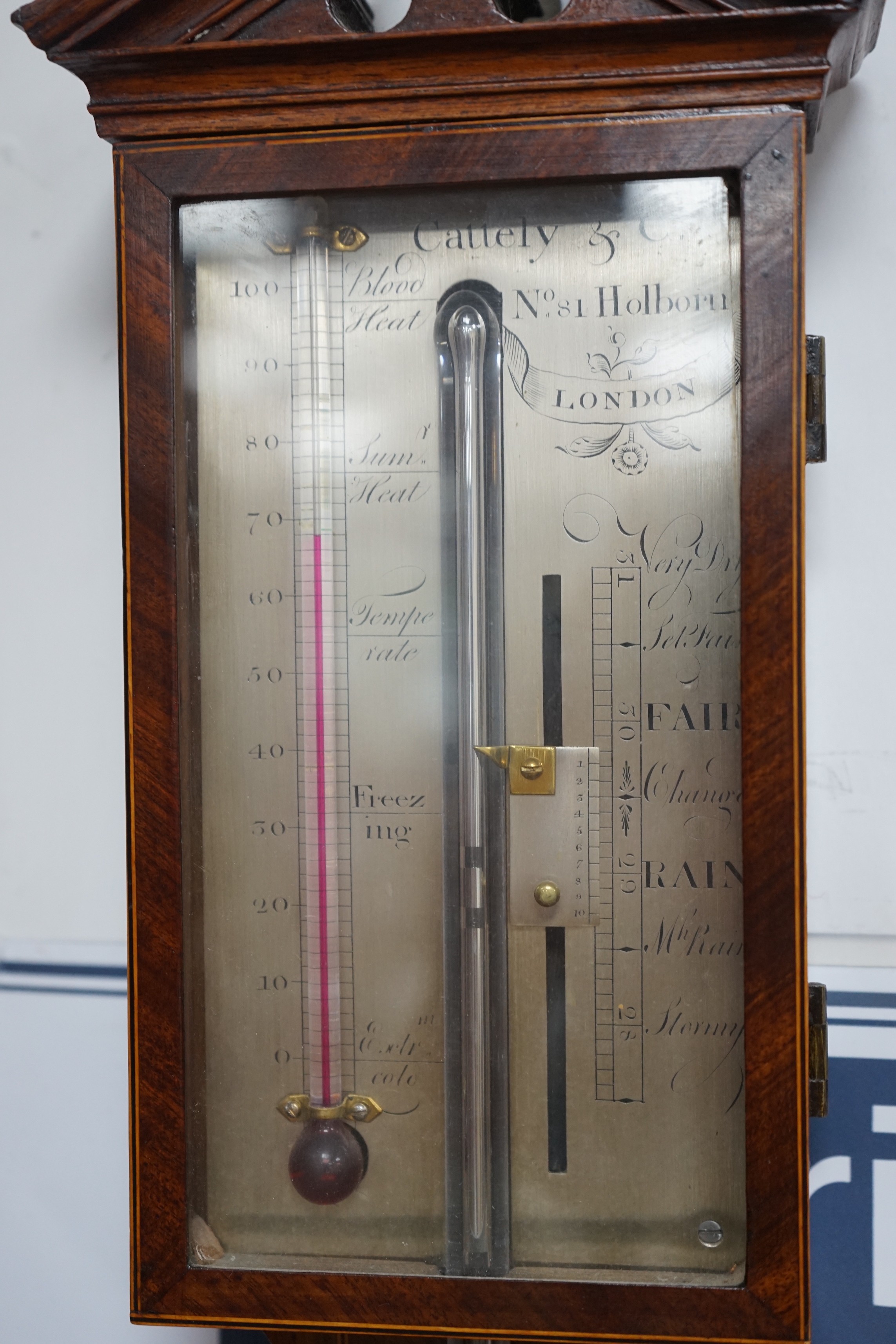 Cattely & Co, Holborn, London. A George III feathered walnut stick barometer, height 98cms. Height 98 cm